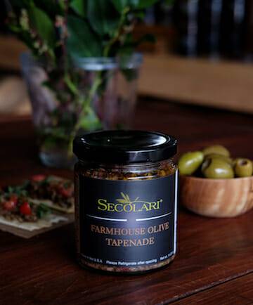 Farmhouse Olive Tapenade, 0.9297 oz , Made from All-natural California Olives on wooden table along with olives