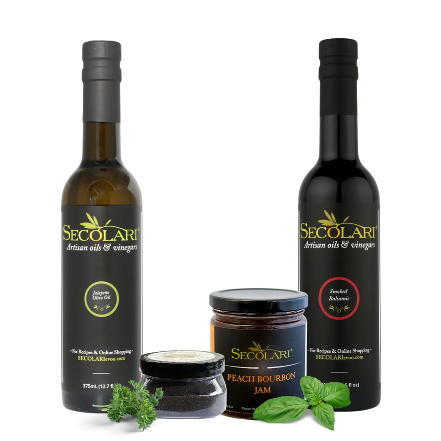 Secolari olive oil and vinegar bottles with a jar of peach bourbon jam on a white background